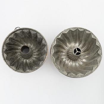 Four copper cake moulds. 18th and 19th Century.