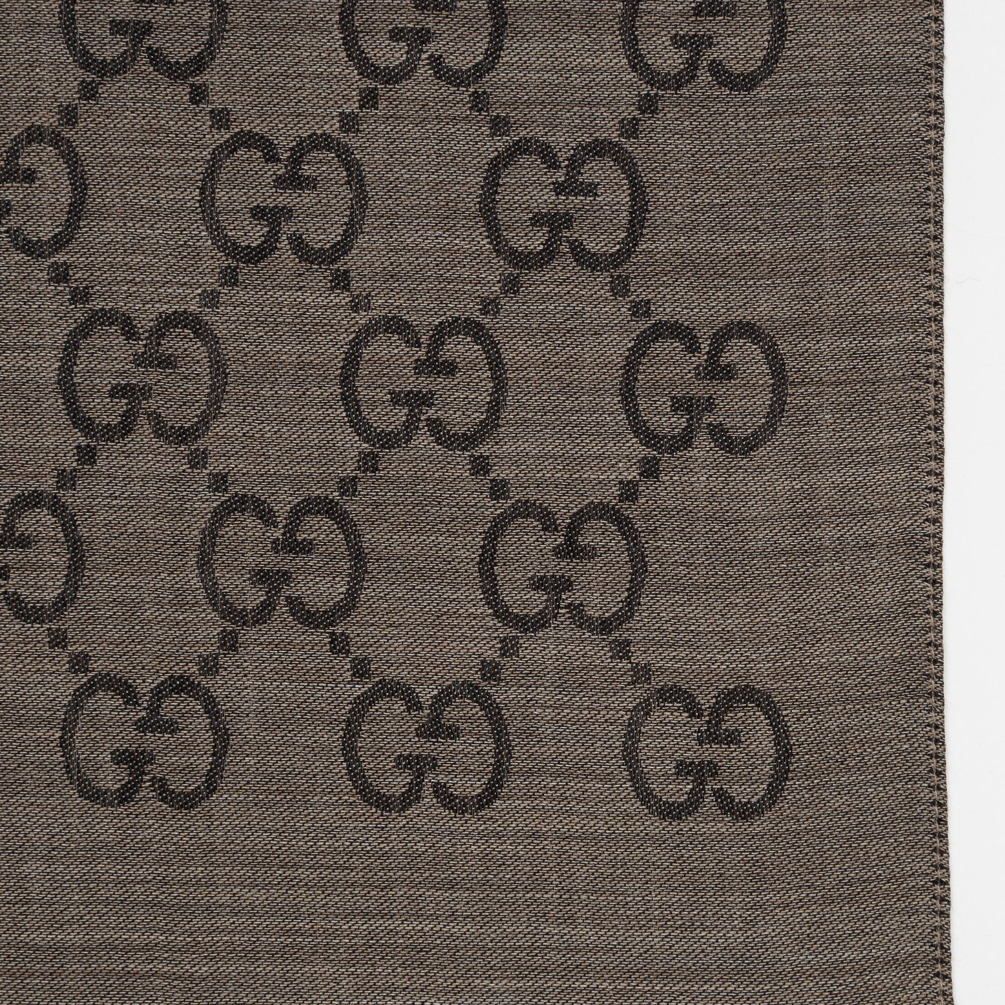 Gucci, a wool and silk mix "GG" jaquard shawl.