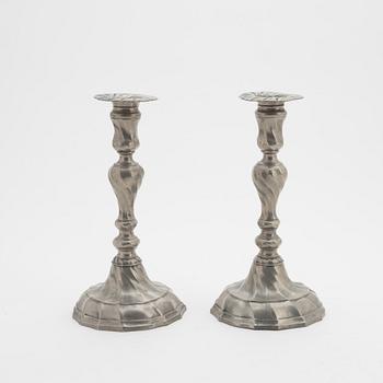 A pair of rococo-style pewter candlesticks, first half of the 20th Century.