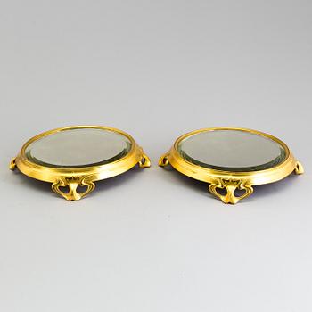 A pair of bronze art nouveau table plateaus,