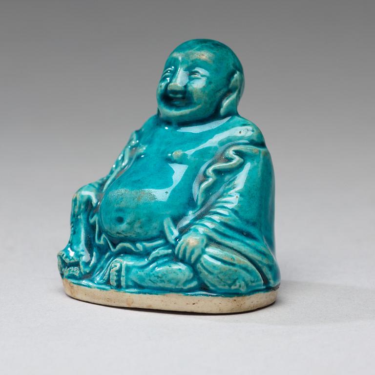 A turquoise glazed figure of Buddai, Qing dynasty, early 18th Century.