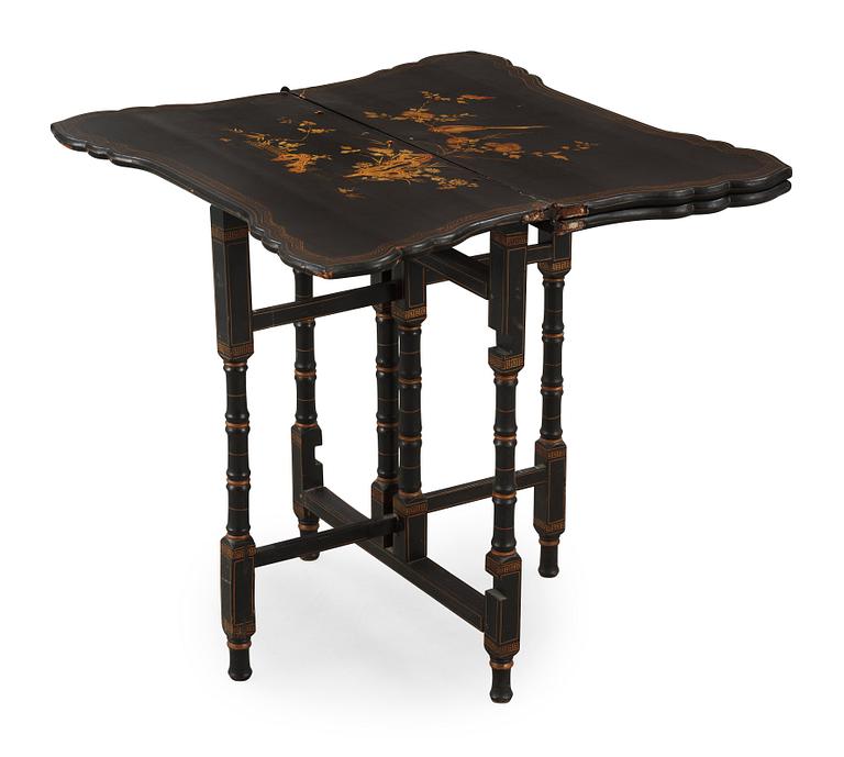 A black and gold laquered games table, 18-19th century.