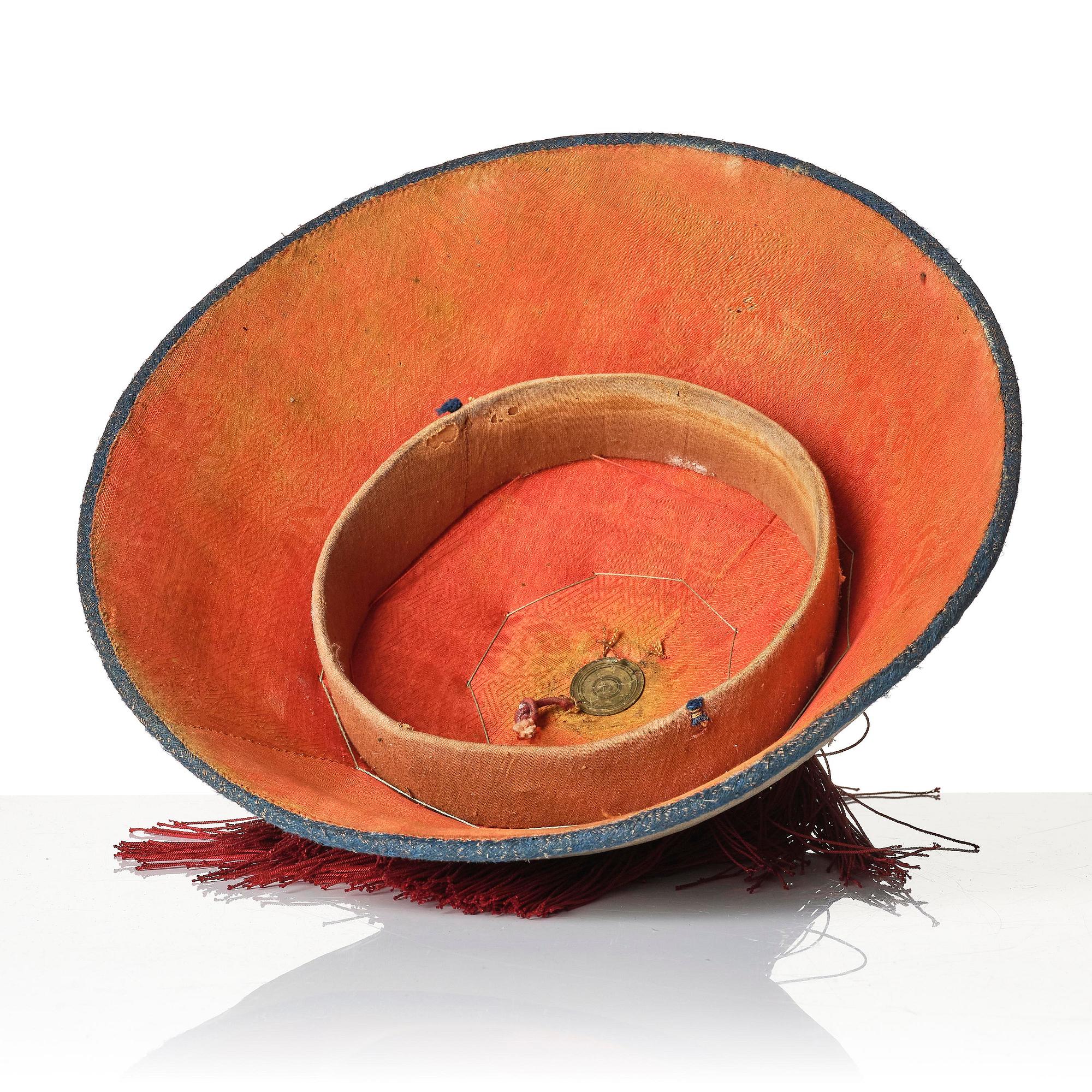 Two boxes with a mandarin's summer hat and black satin autumn hat and feather with six mandarin hat insignias.