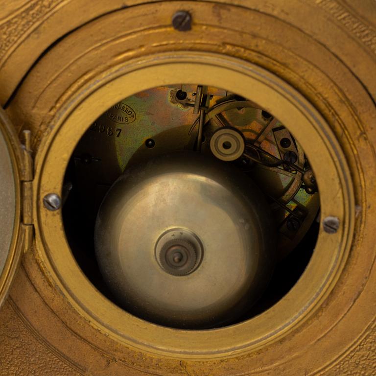 A table clock and two candelabras from the late 19th century.