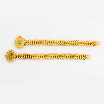 A bracelet/necklace combination in 14K gold set with faceted emeralds.