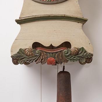 a painted wall pendulum clock from Ångermanland in the first half of the 19th century.