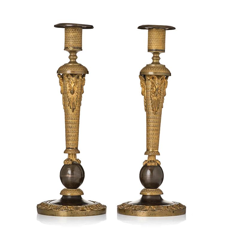 A pair of Russian Empire ormolu and patinated bronze candlesticks, Moscow circa 1800.