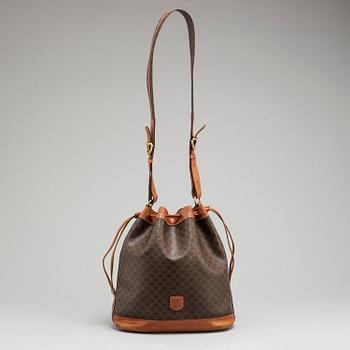 CÉLINE, a monogram canvas bucket bag.