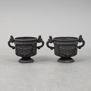 Two 20th Century cast iron flower pots.