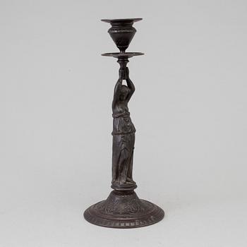 A 19th century iron candlestick marked F.L Vombach Offenbach A/M.