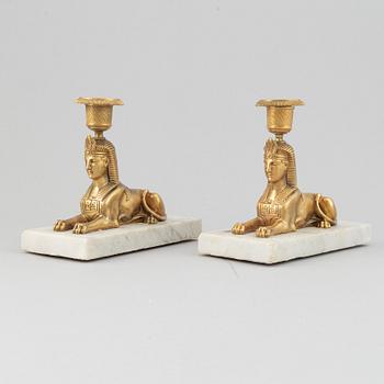 A pair of empire style 19th century candlesticks.