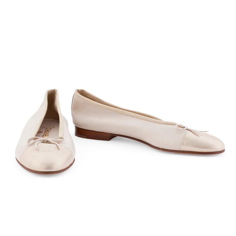 CHANEL, a pair of beige leather ballet flats.