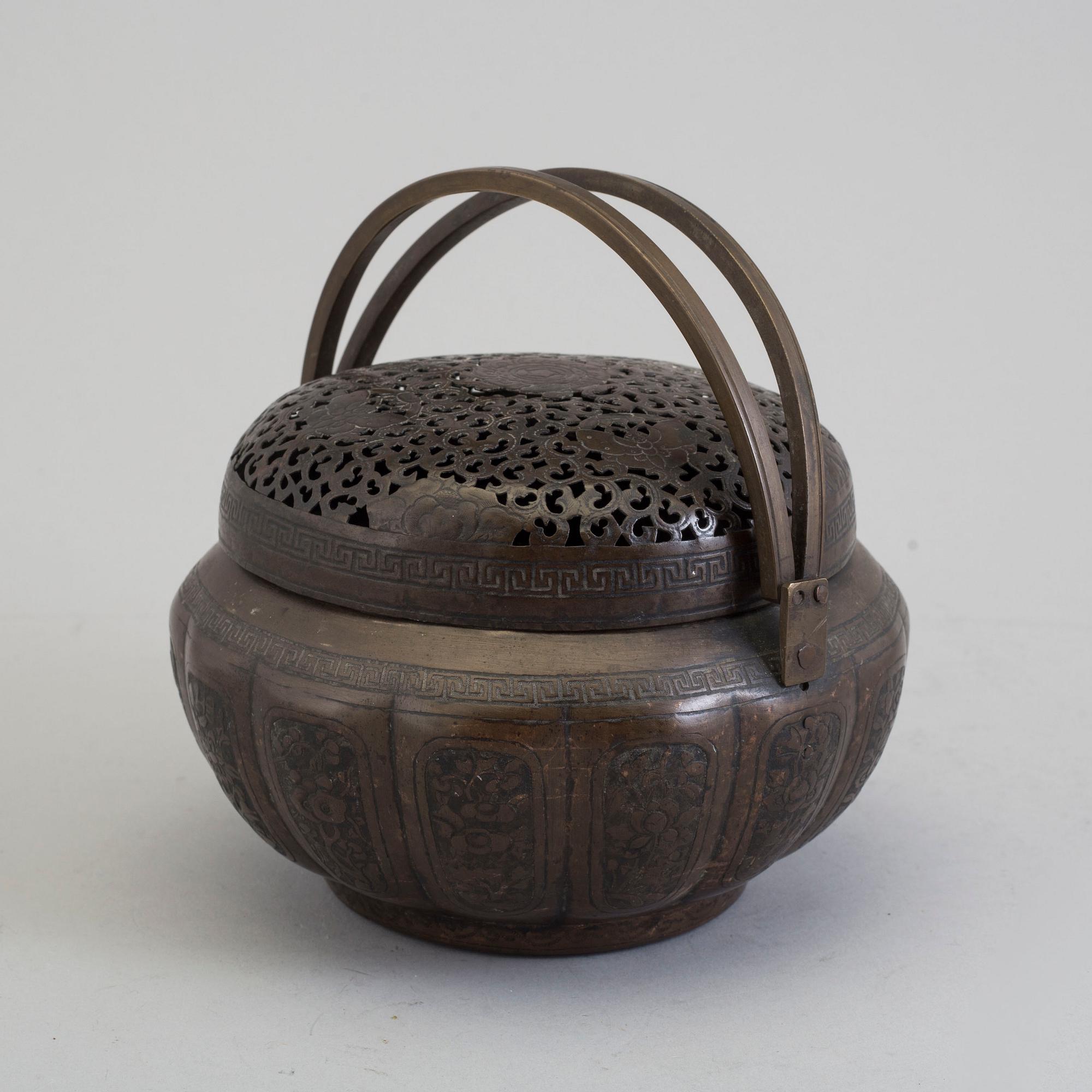 A Chinese engraved bronze hand warmer, late Qing dynasty,