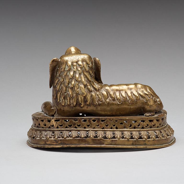 A copper alloy figure of a reclining buddhist lion, presumably 18th Century.