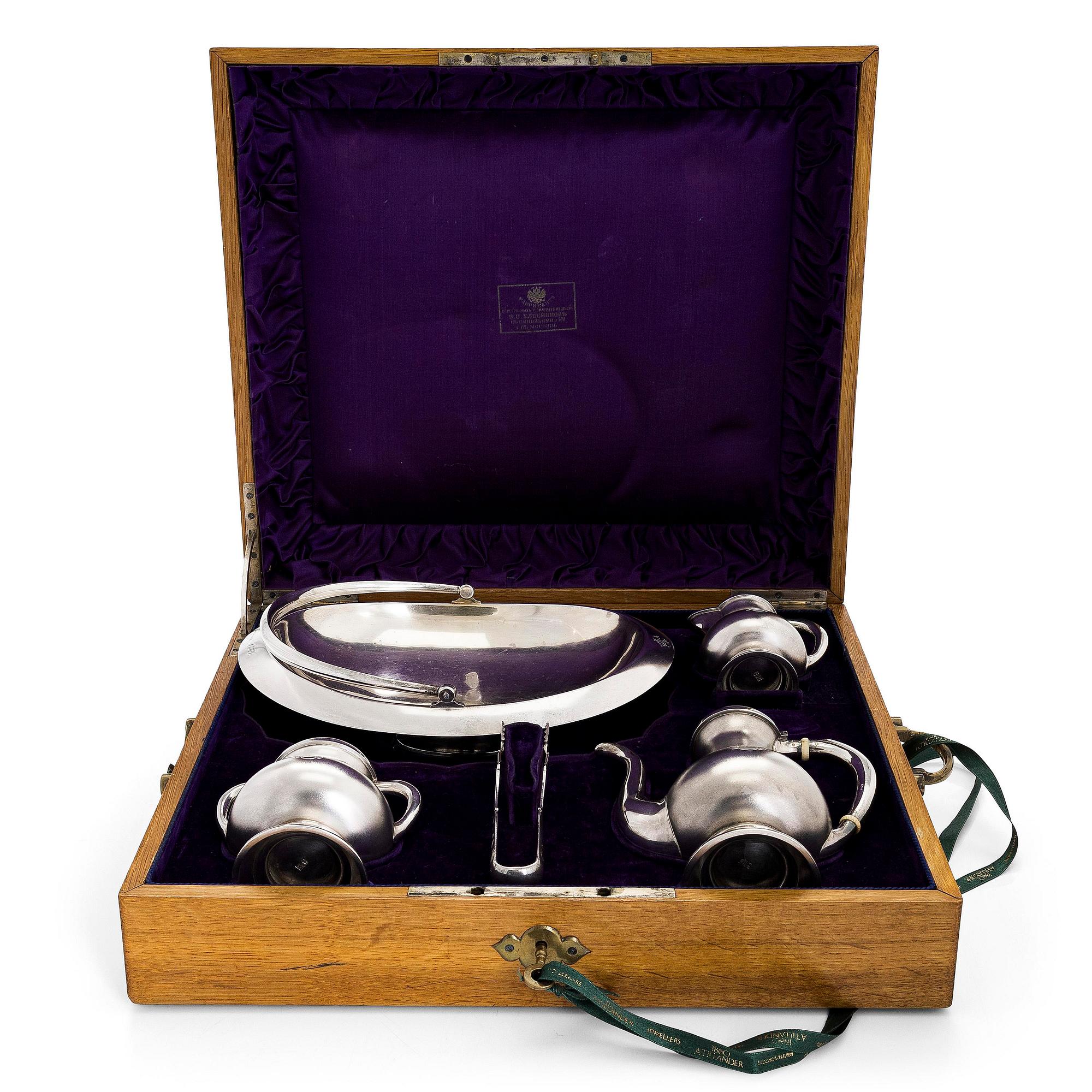 A four-piece silver coffee set, St. Petersburg 1887, original fitted box from Khlebnikov. Sugar tong, Moscow around 190.