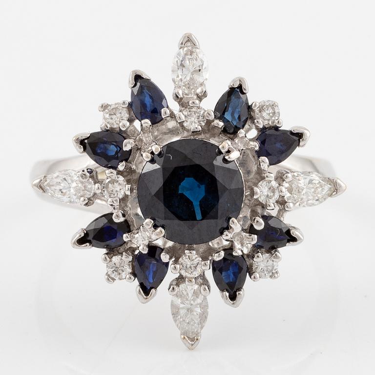 Ring 18K white gold with dark sapphires, pear-shaped and brilliant-cut diamonds.