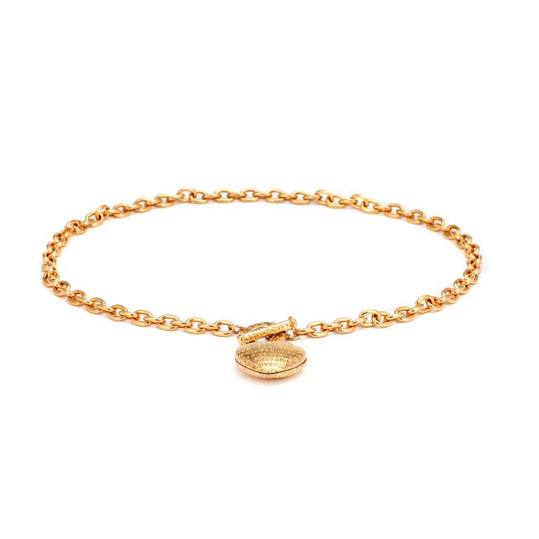 GIVENCHY, a gold colored necklace with heart shaped pendant.