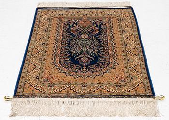 A semi-antique silk Hereke rug, West Anatolia, signed c. 107 x 72 cm.
