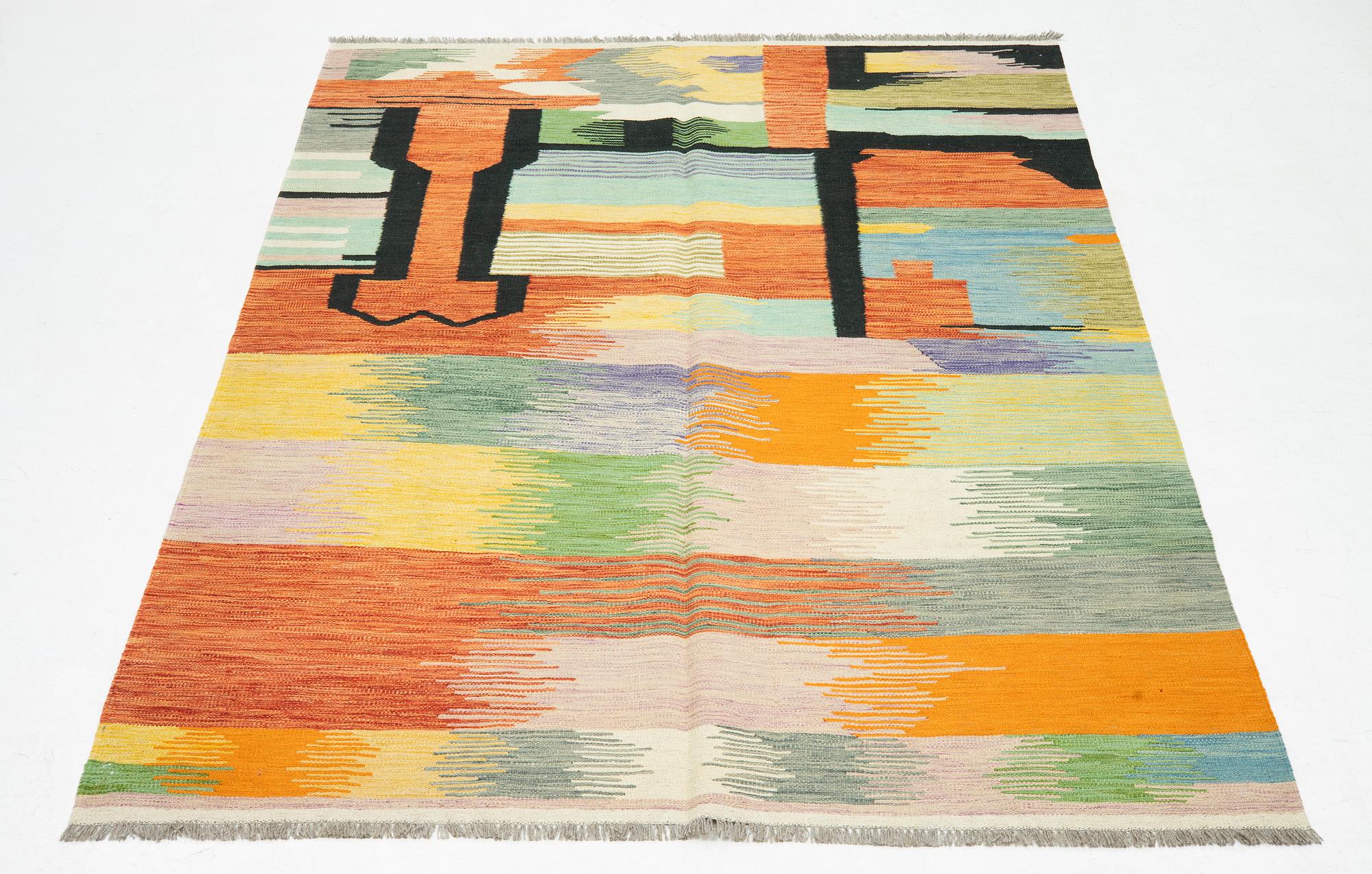 A kilim rug, 247 x 170 cm.