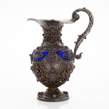 A parcel-gilt silver jug with enamel, and cabochon cut amethysts. First half of the 20th century.