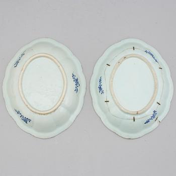 Two blue and white export porcelain tureens with covers and three dishes, Qing dynasty, 18th century.