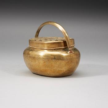 A Chinese engraved paktong hand warmer, Qing dynasty, 19th Century.