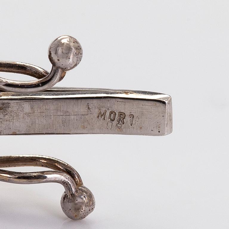 Rannekoru, 18K valkokultaa ja monivärisiä kiviä.