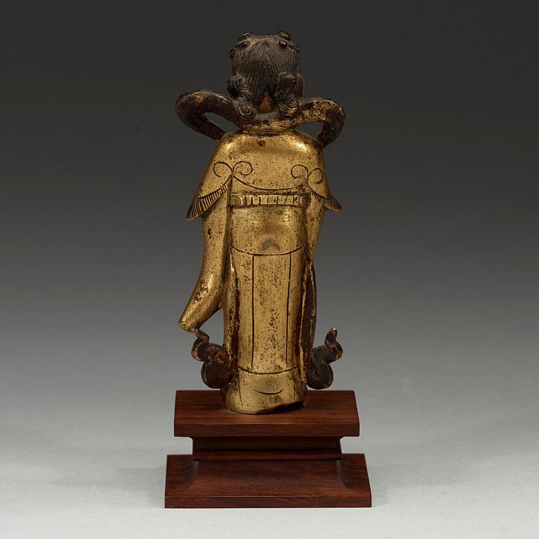A gilt bronze figure of Longnü, Ming Dynasty, 17th century.