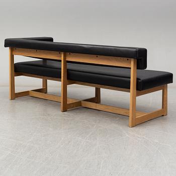 A leather covered oak sofa, 21st Century.