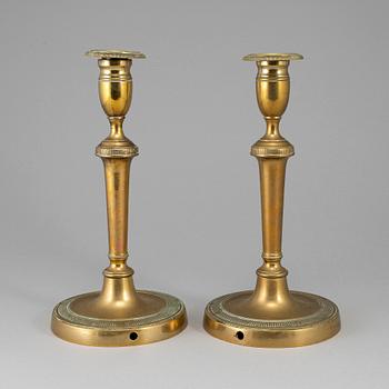 A pair of late 18th century bronze candlesticks.