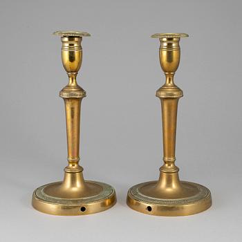 A pair of late 18th century bronze candlesticks.