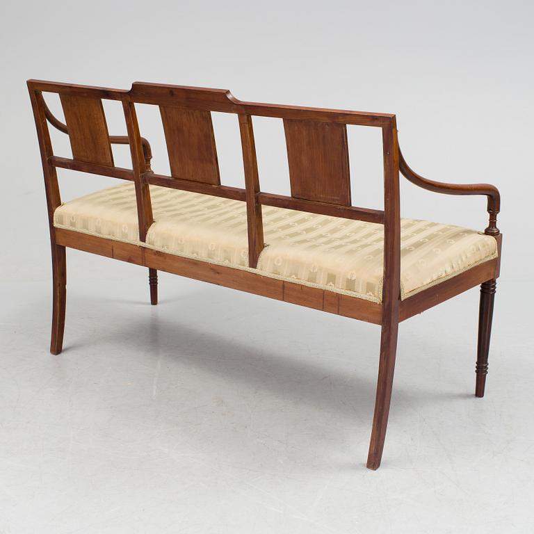A 1920/30s Swedish Grace sofa, a pair of chairs, a pair of armchairs and a table veneered with mahogany.