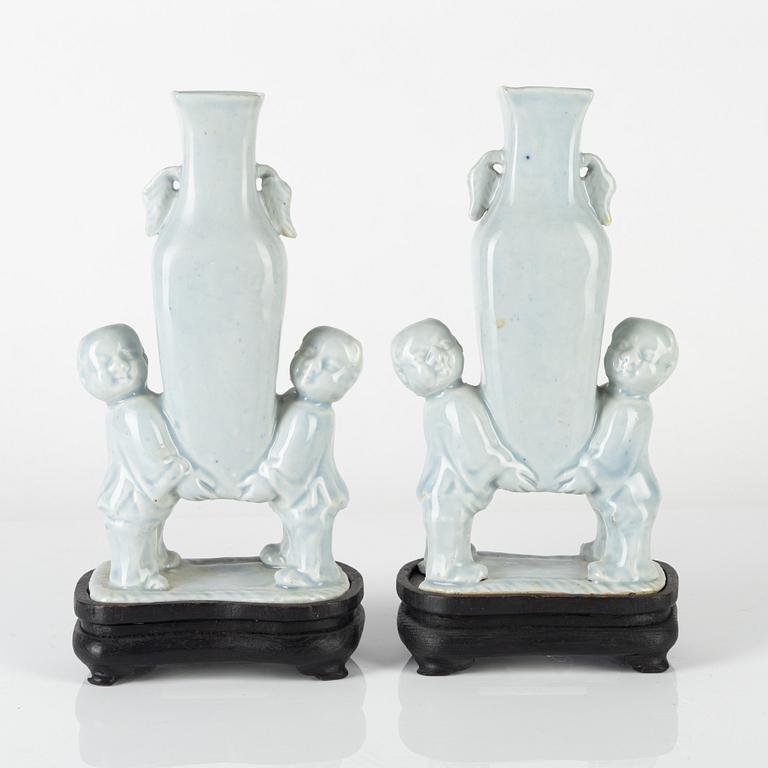 A pair of Chinese pale blue boys vases, around 1900.