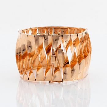 A 14K gold bracelet and a brooch.
