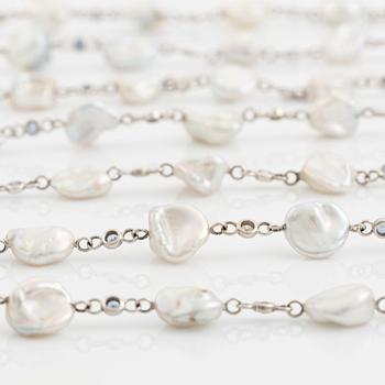 A Seaman Schepps 18K gold and cultured fresh water pearl necklace set with sapphires.