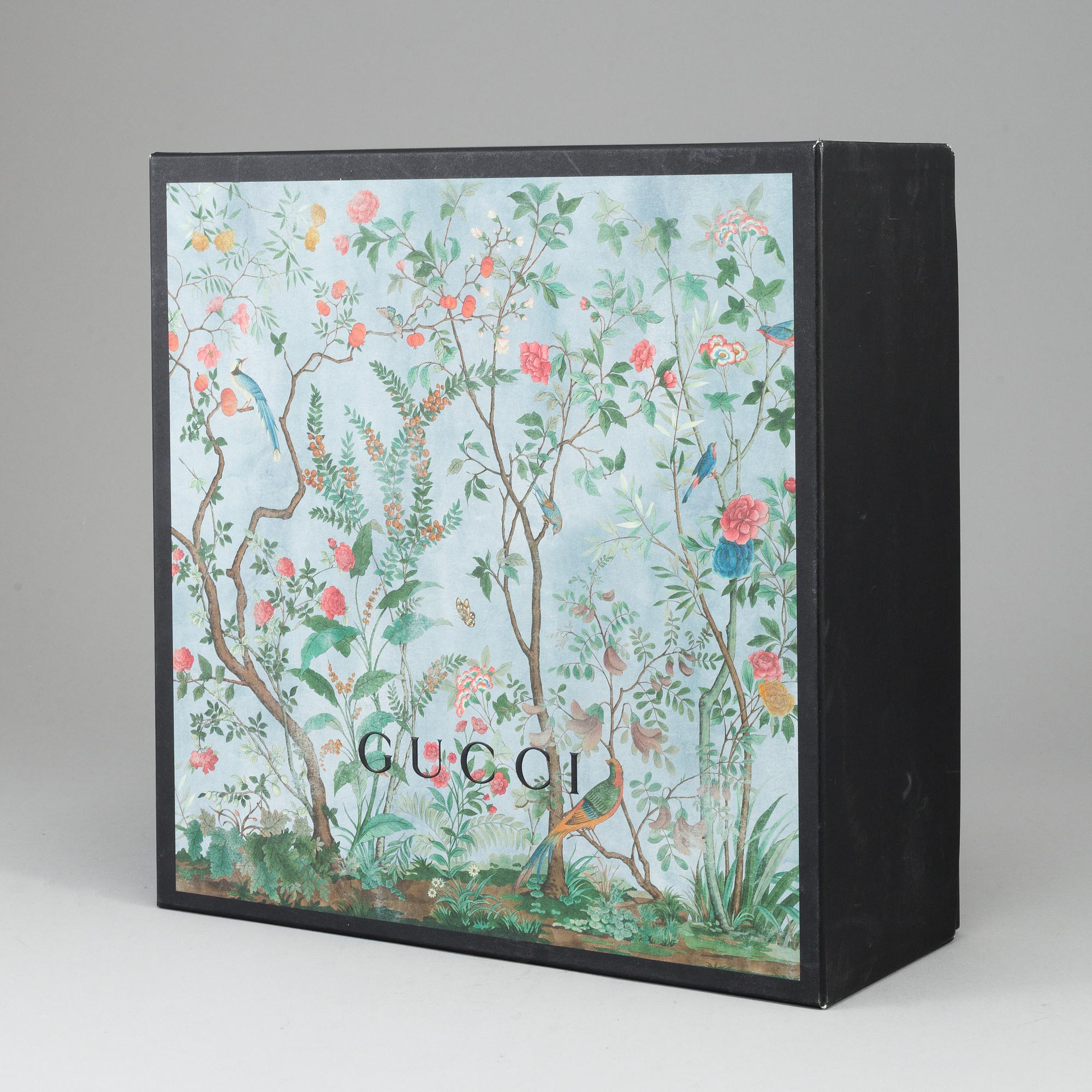 GUCCI, a patterned monogram canvas and leather bag.