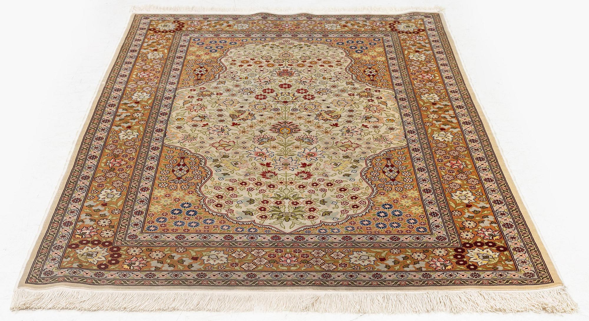 A double-nisch silk Hereke rug, c. 125 x 78 cm.