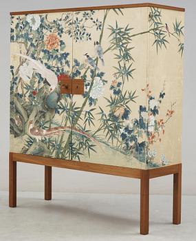 A Josef Frank mahogany cabinet, the sides and doors covered in handpainted wallpaper, Svenskt Tenn, circa 1950.