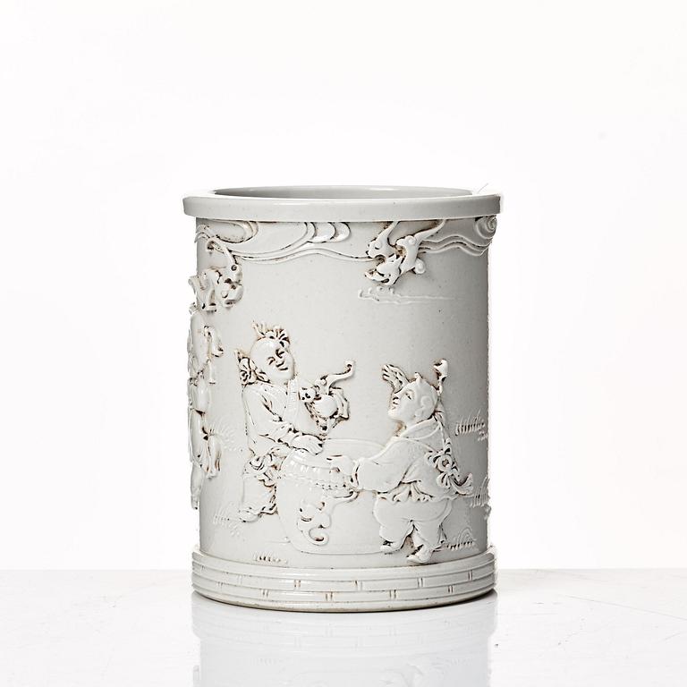 A white glazed Chinese brush pot, presumably late Qing dynasty.