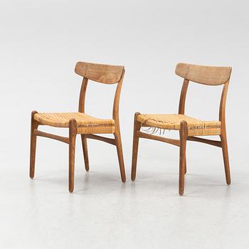 Hans J Wegner, a pair of model 'CH-23' oak and rattan chairs, Carl Hansen & Son, Odense, Denmark.