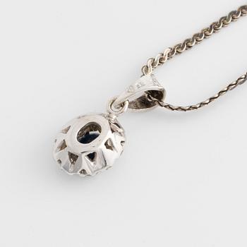 Pendant and a pair of earrings, white gold with sapphires and brilliant-cut diamonds.