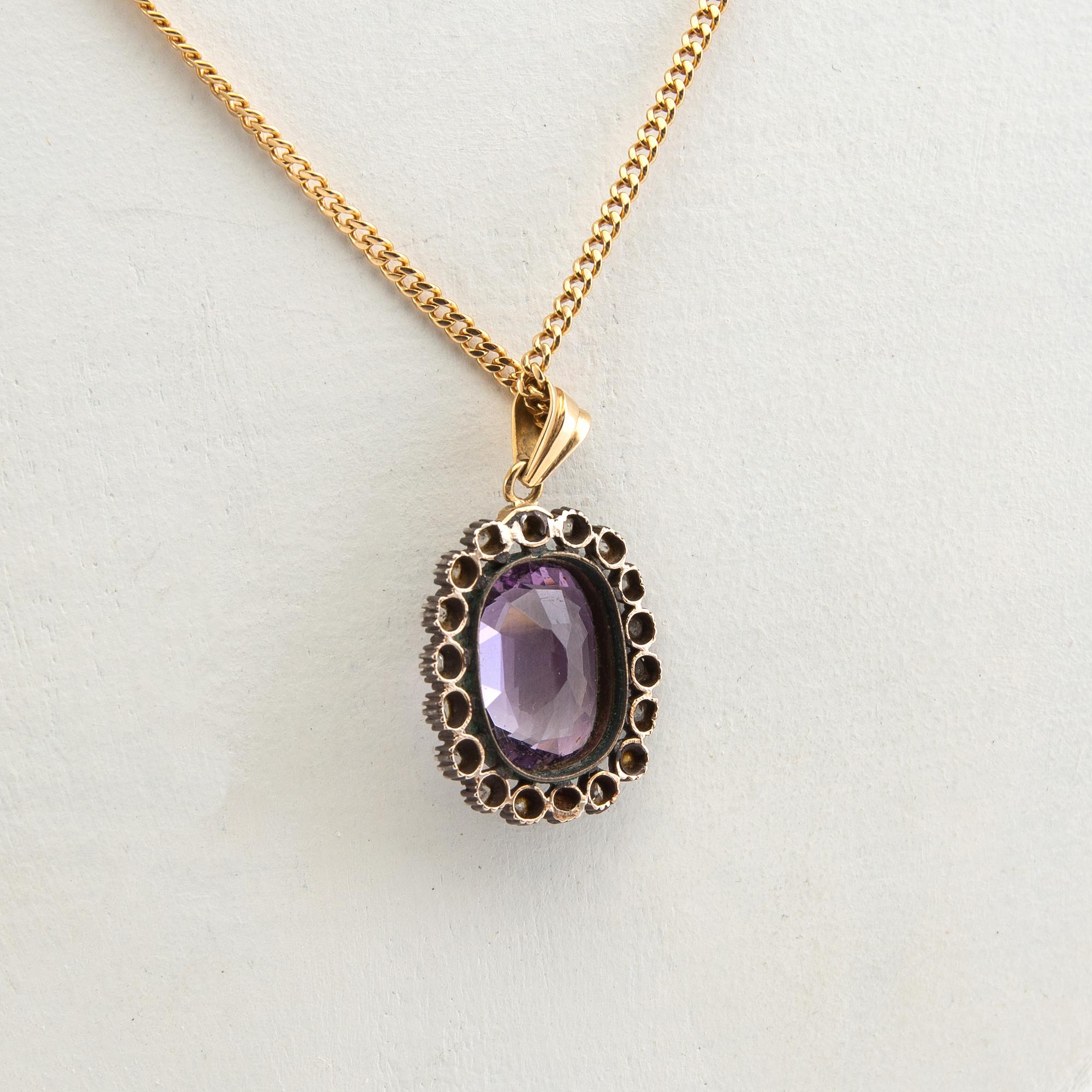 Pendant, 18k gold with diamonds and purple stone.