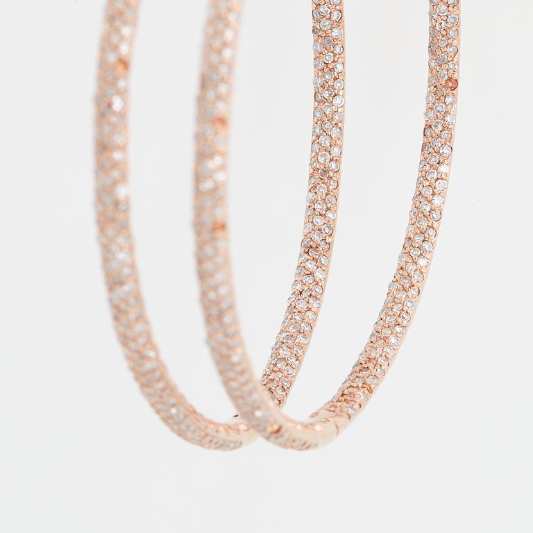Rose gold and diamond hoop earrings.