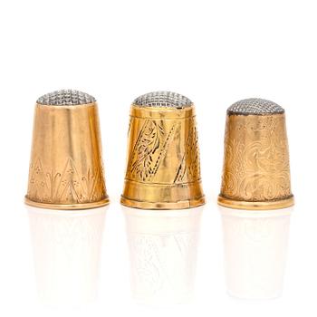 Three 18K gold thimbles.