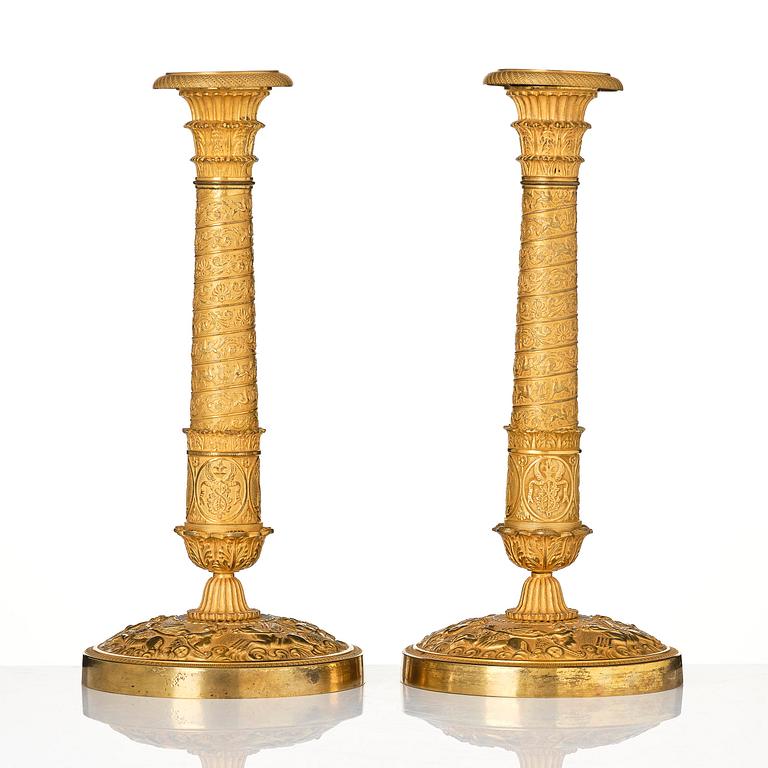 A pair of French Empire ormolu candlesticks, Paris, early 19th century.