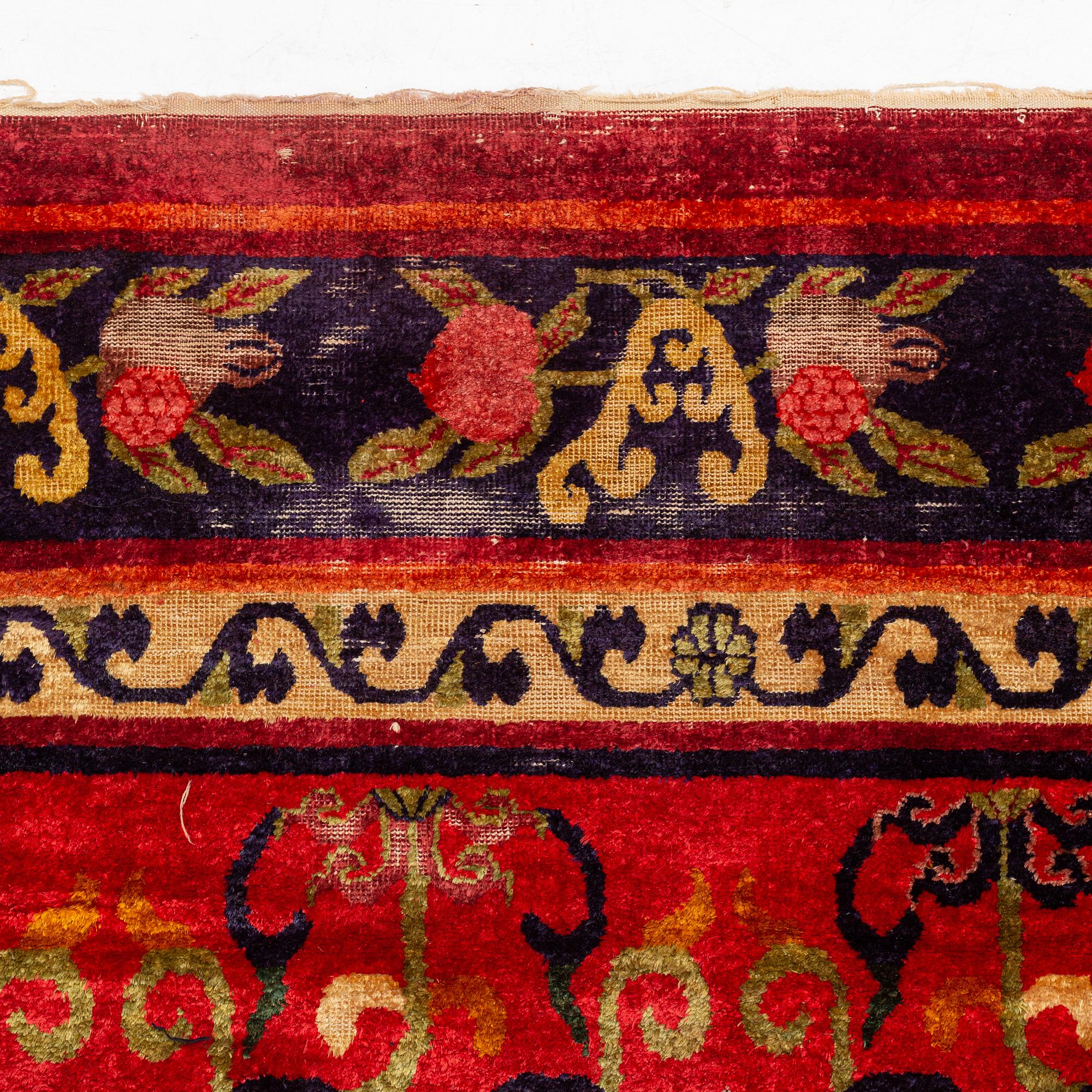 An East Turkestan silk carpet, ca 308 x 182 cm.