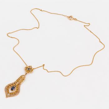 A necklace set with seed pearls, a cabochon cut sapphire, probably another sapphire and filigree work.