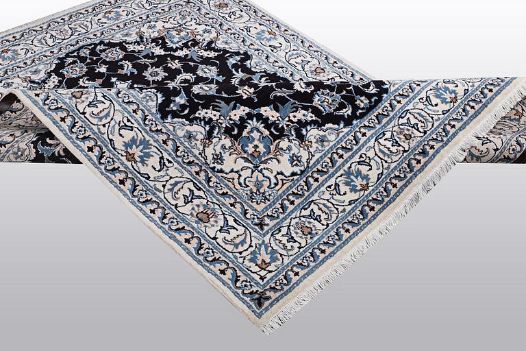 A rug, Nain, part silk, ca 242 x 167 cm.