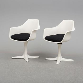 A dining table and eight chairs by Robin Day, Arkana.