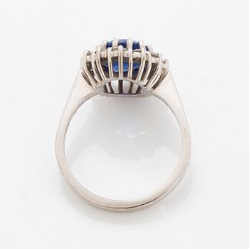 Oval faceted sapphire and brilliant-cut diamond ring.